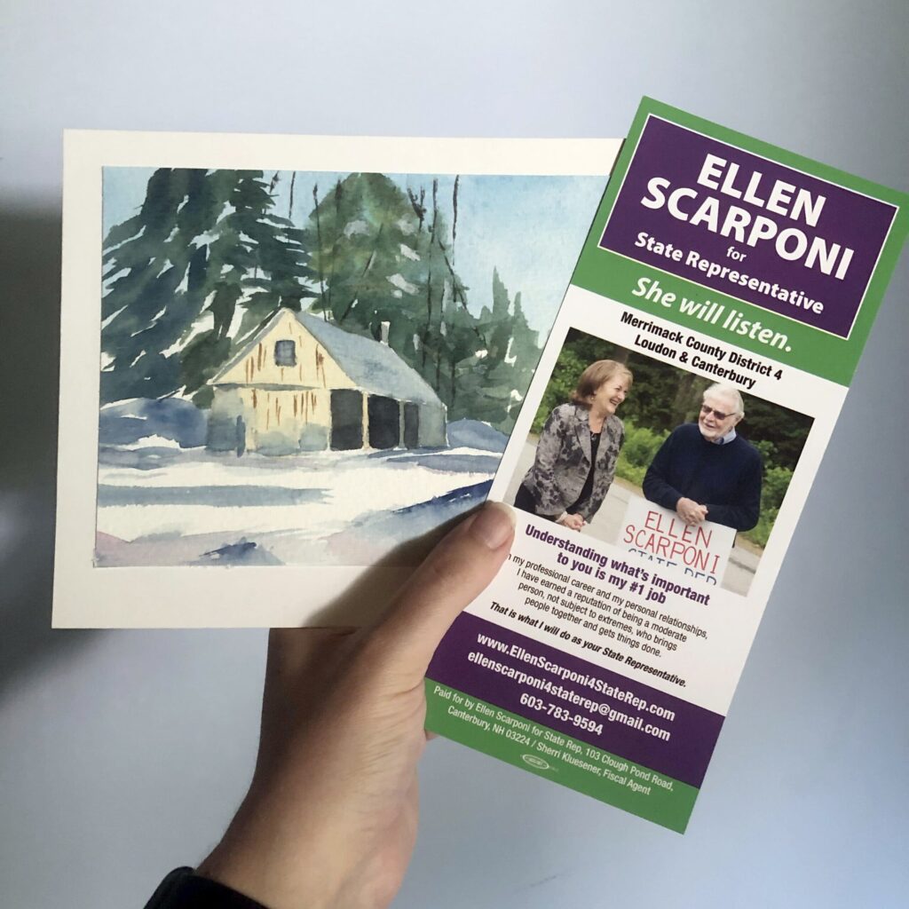 Ellen Scarponi's State Rep campaign handout, held up with a small watercolor of a building in snow with trees. 